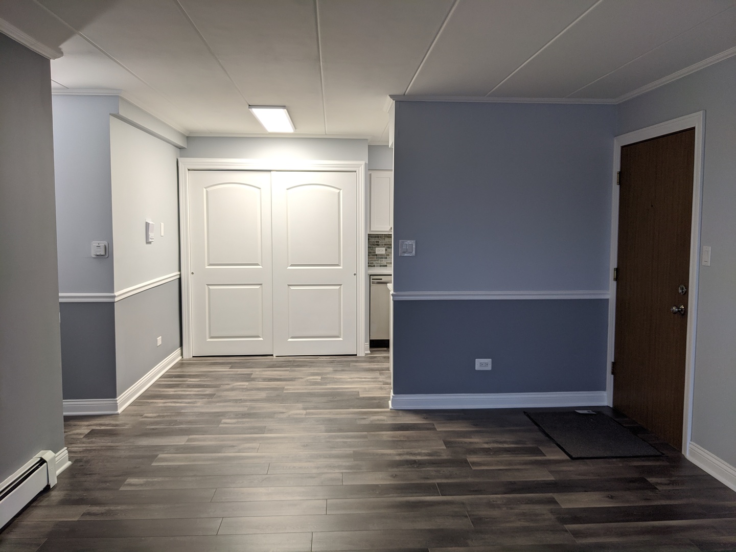 10440 South Ridgeland Avenue, Unit 5 Chicago Ridge, IL 60415 - Photo 8 of 27 an empty room with wooden floor and cabinet