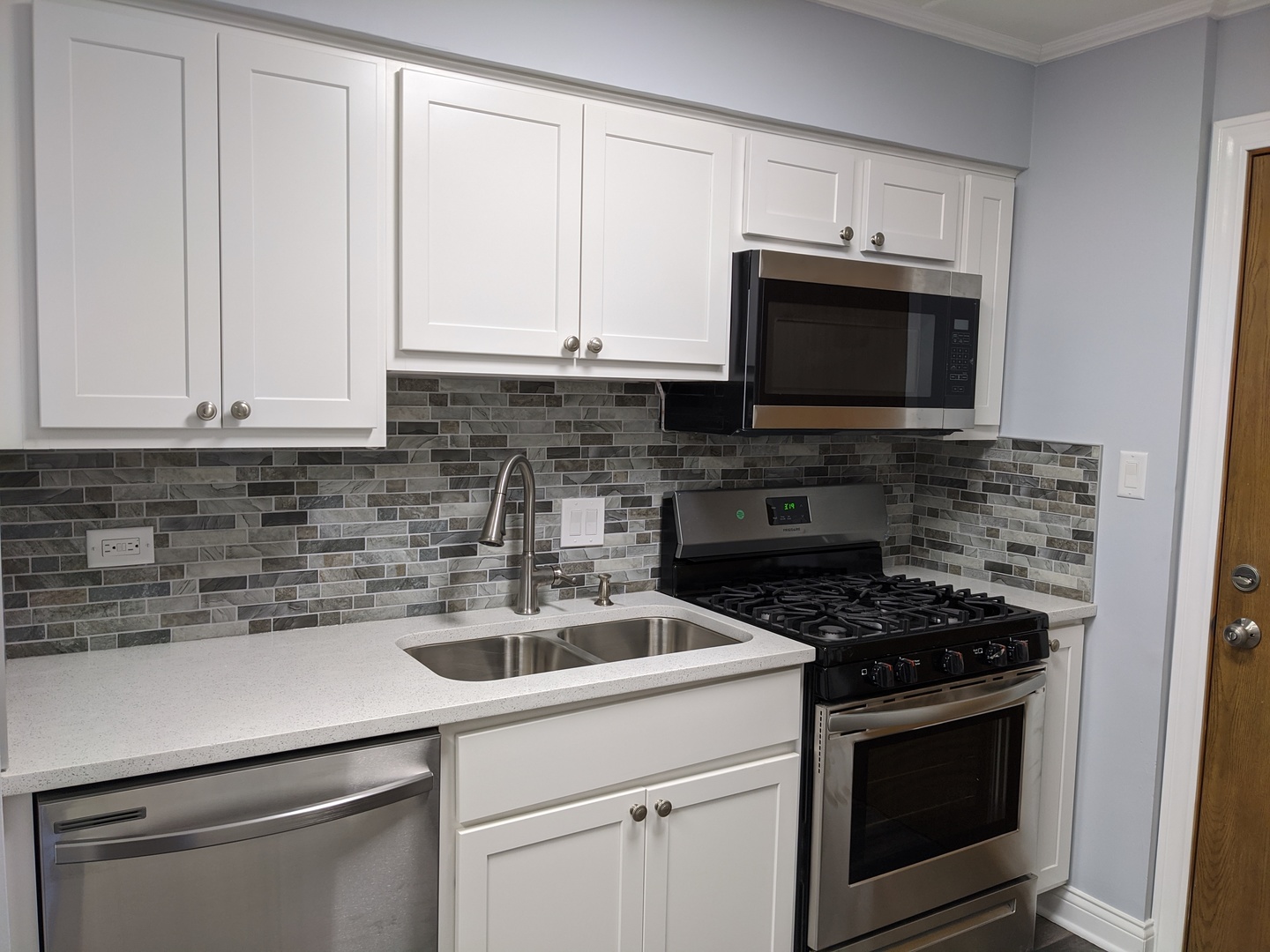 10440 South Ridgeland Avenue, Unit 5 Chicago Ridge, IL 60415 - Photo 10 of 27 a kitchen with cabinets stainless steel appliances and a sink