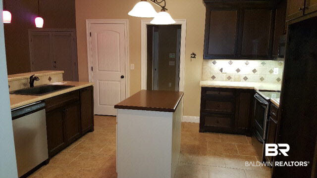 42360 Pine Grove Road Bay Minette, AL 36507 - Photo 23 of 25 Beautiful tile back splash. Pantry door to left of laundry