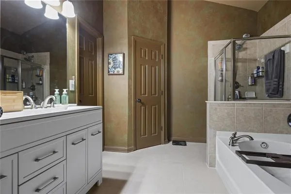 a bathroom with a double vanity sink toilet and a tub