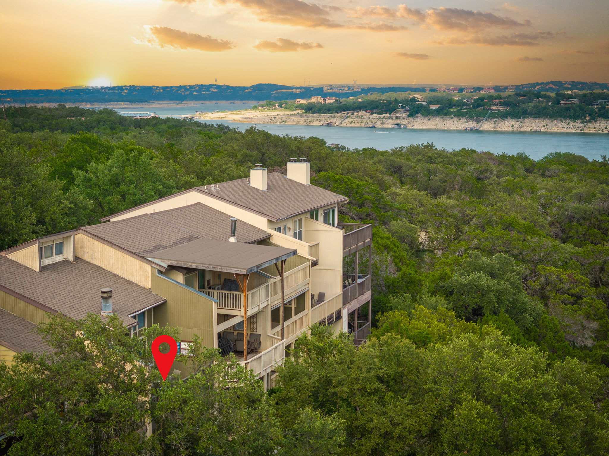229 Comanche Lane Point Venture, TX 78645 - Photo 3 of 38 an aerial view of a house with a garden and lake view