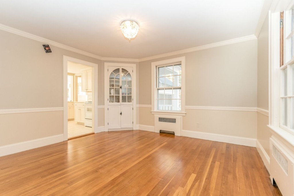 10 Fuller Road Needham, MA 02492 - Photo 3 of 10 an empty room with wooden floor and windows