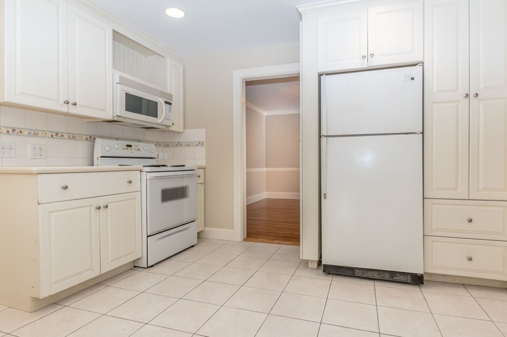 10 Fuller Road Needham, MA 02492 - Photo 6 of 10 a kitchen with white cabinets and white appliances