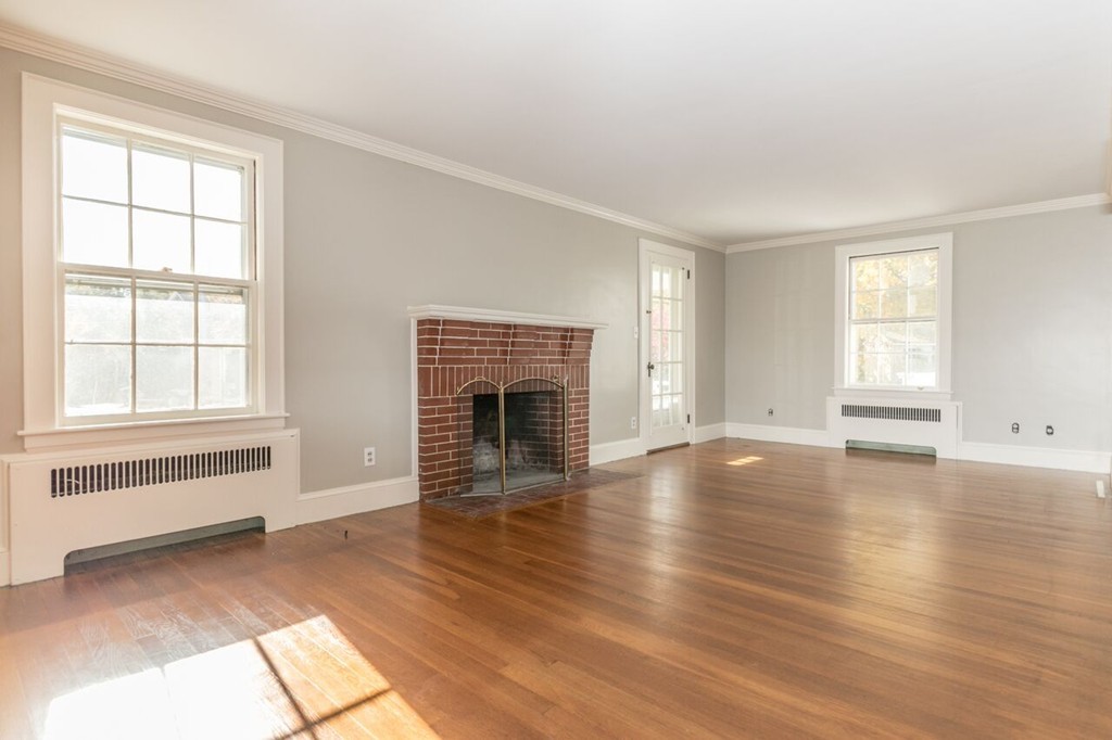 10 Fuller Road Needham, MA 02492 - Photo 7 of 10 a view of empty room with wooden floor and fireplace