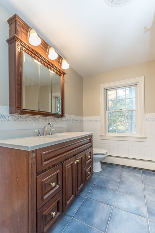 10 Fuller Road Needham, MA 02492 - Photo 9 of 10 a bathroom with a granite countertop sink a mirror and a bathtub