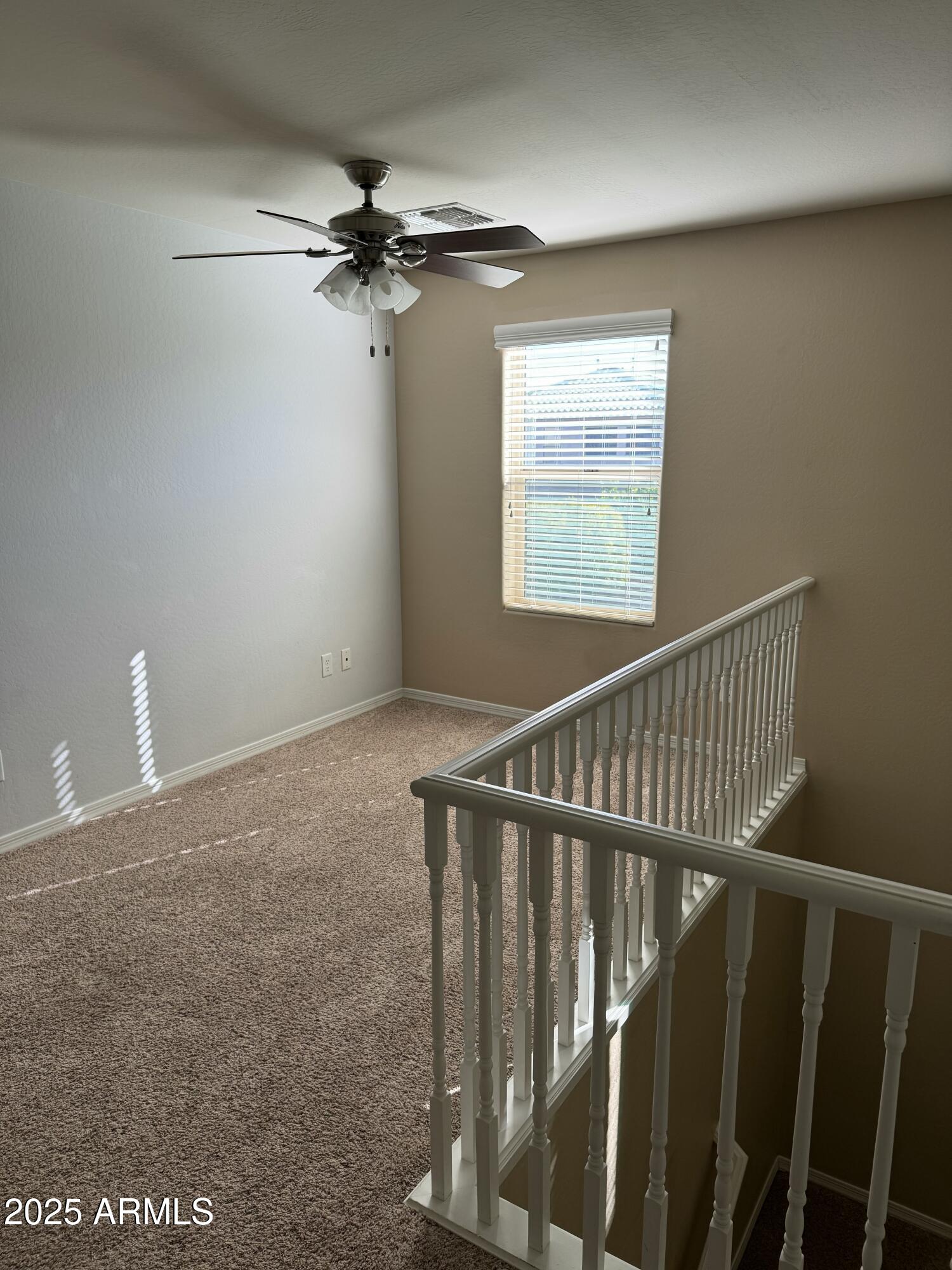 11009 East Sutter Avenue Mesa, AZ 85212 - Photo 15 of 32 a view of an empty room with wooden floor and a window