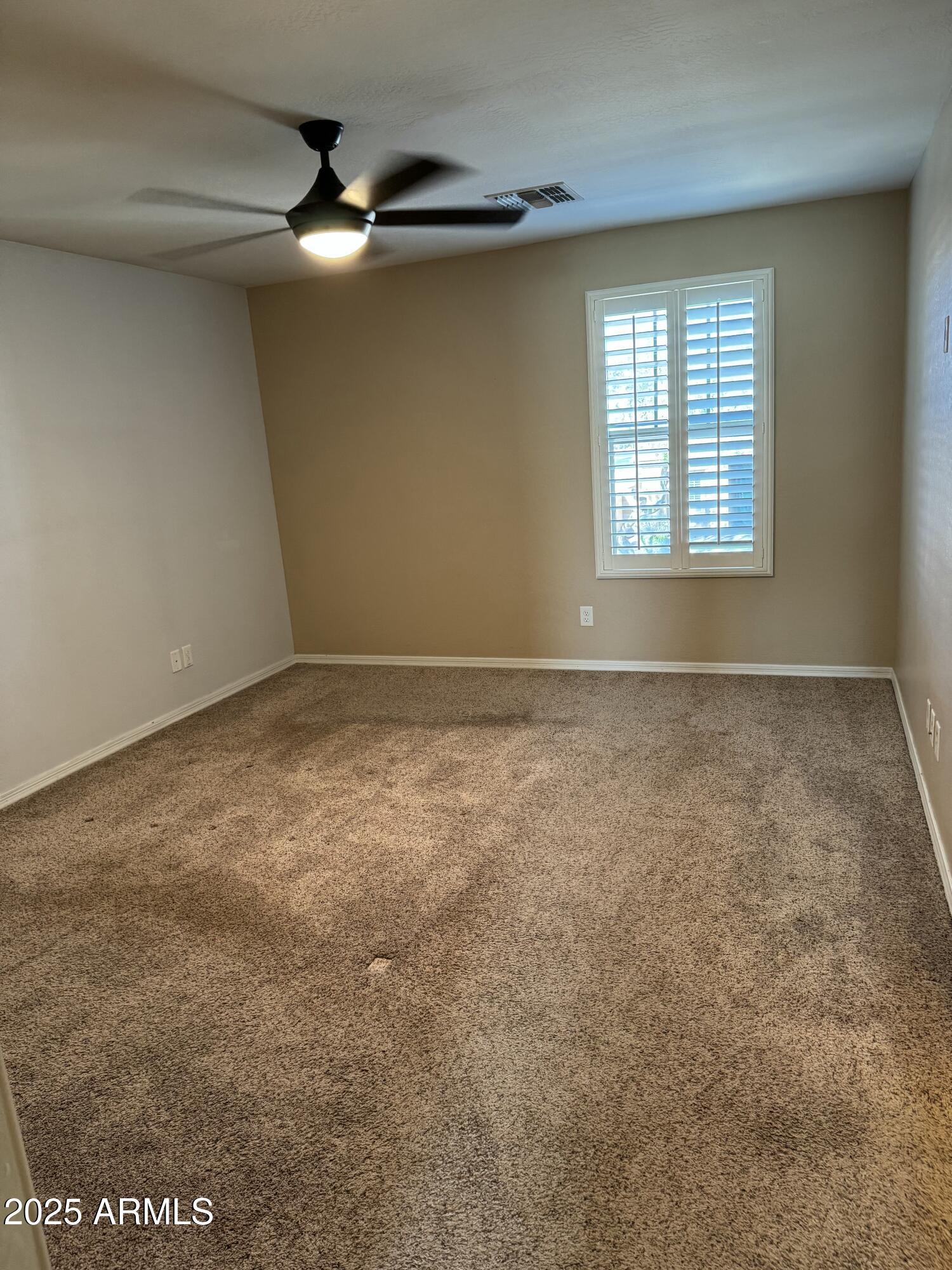 11009 East Sutter Avenue Mesa, AZ 85212 - Photo 17 of 32 an empty room with windows and fan
