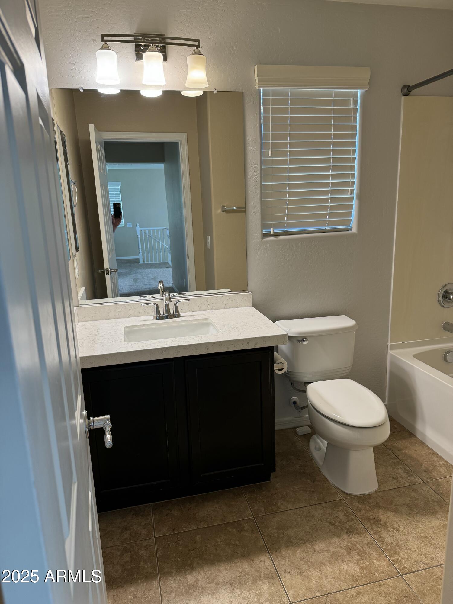 11009 East Sutter Avenue Mesa, AZ 85212 - Photo 26 of 32 a bathroom with a sink vanity and a toilet