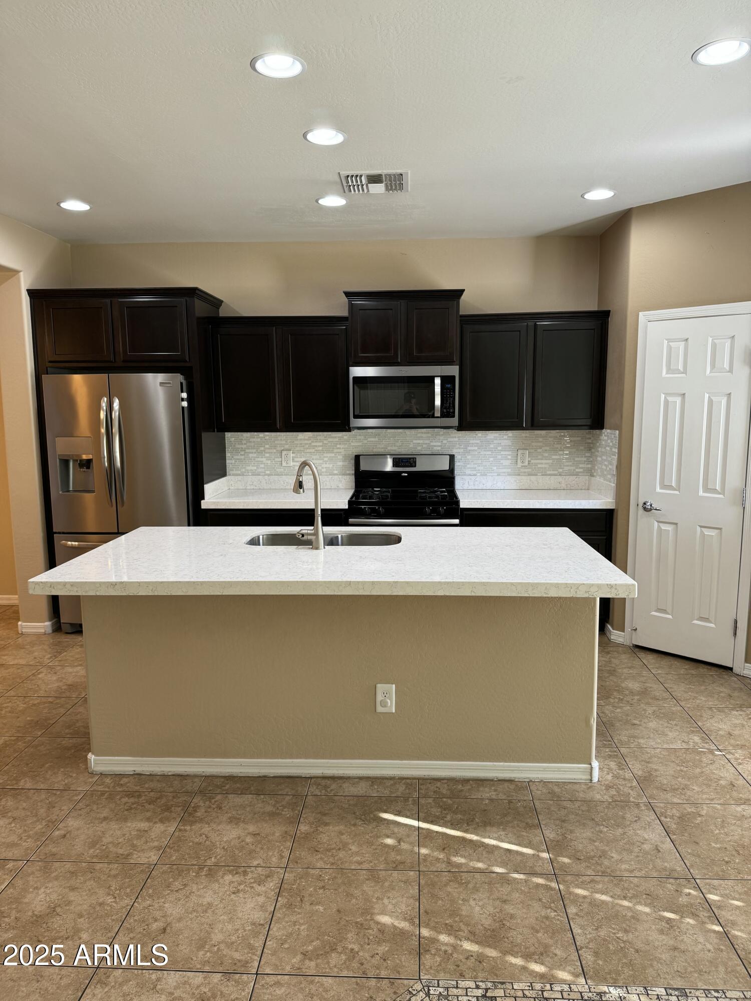 11009 East Sutter Avenue Mesa, AZ 85212 - Photo 5 of 32 a view of kitchen with kitchen island microwave and cabinets