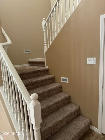 a white toilet sitting in a bathroom next to a window