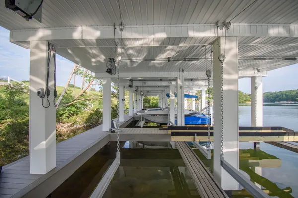 a view of a house with swimming pool and a large tree
