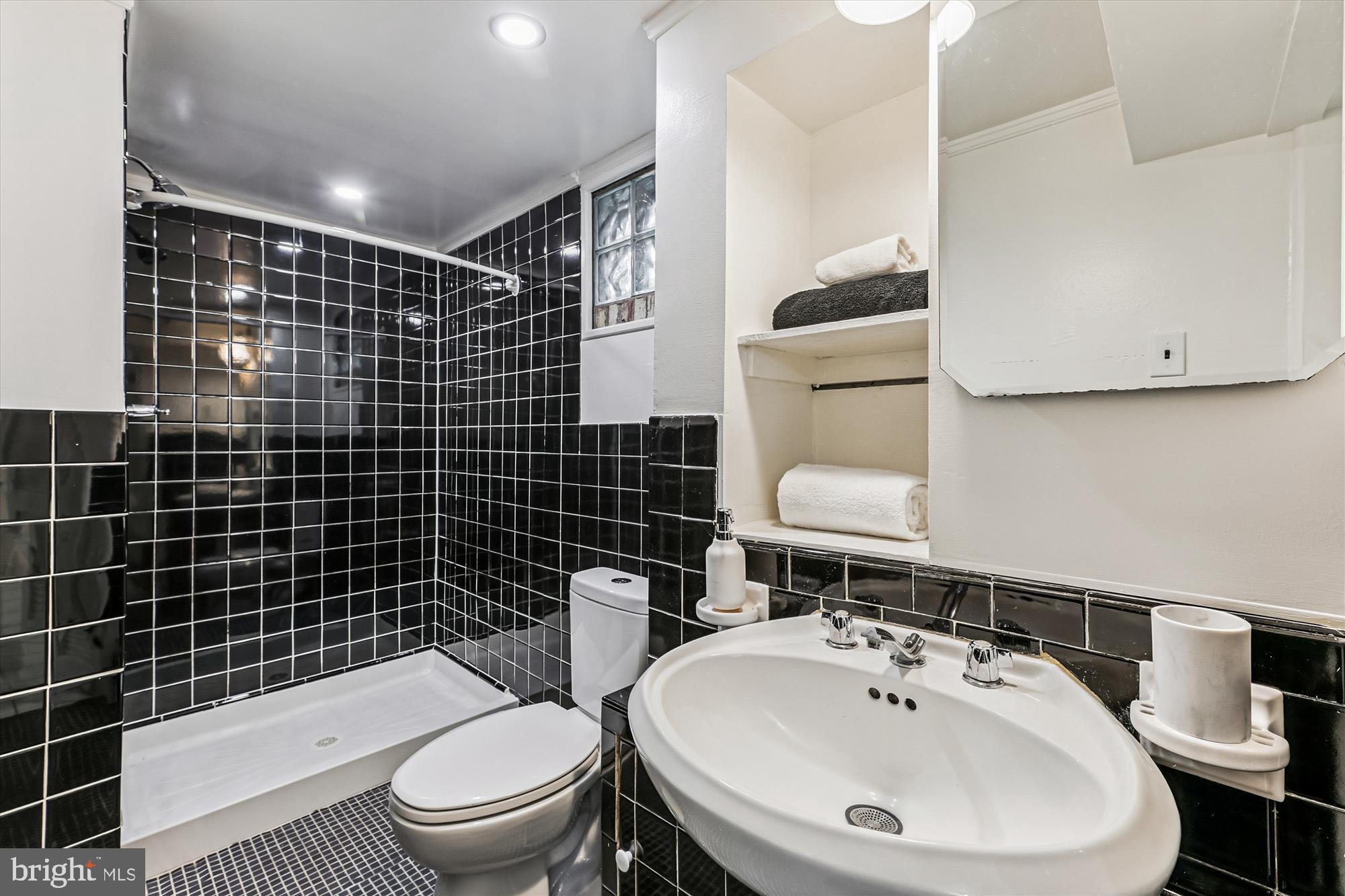 4225 Meade Street Northeast Washington, DC 20019 - Photo 16 of 42 Sleek black and white bathroom retreat.