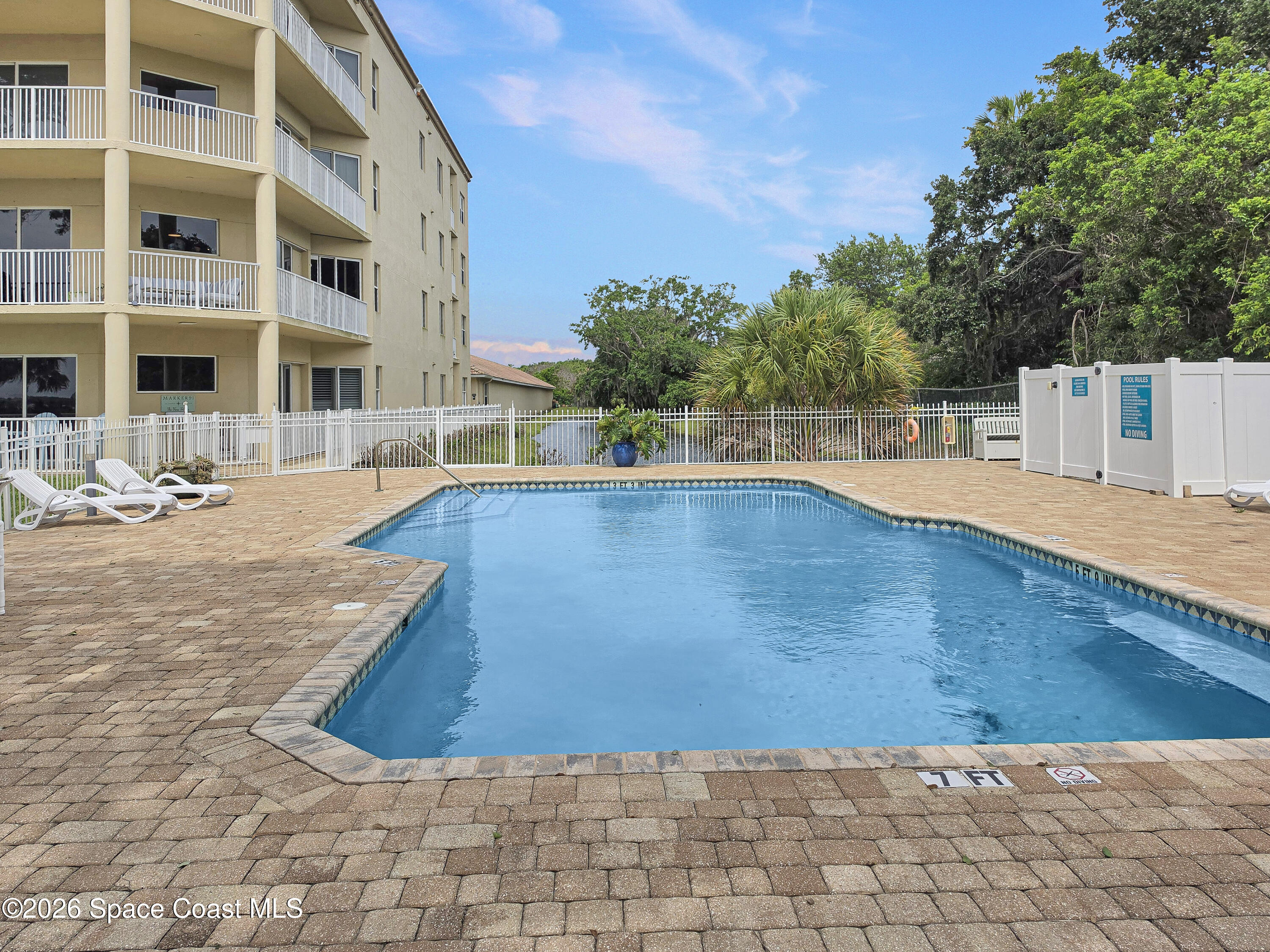6005 Highway 1, Unit 101 Rockledge, FL 32955 - Photo 40 of 57 a view of a swimming pool with a chair