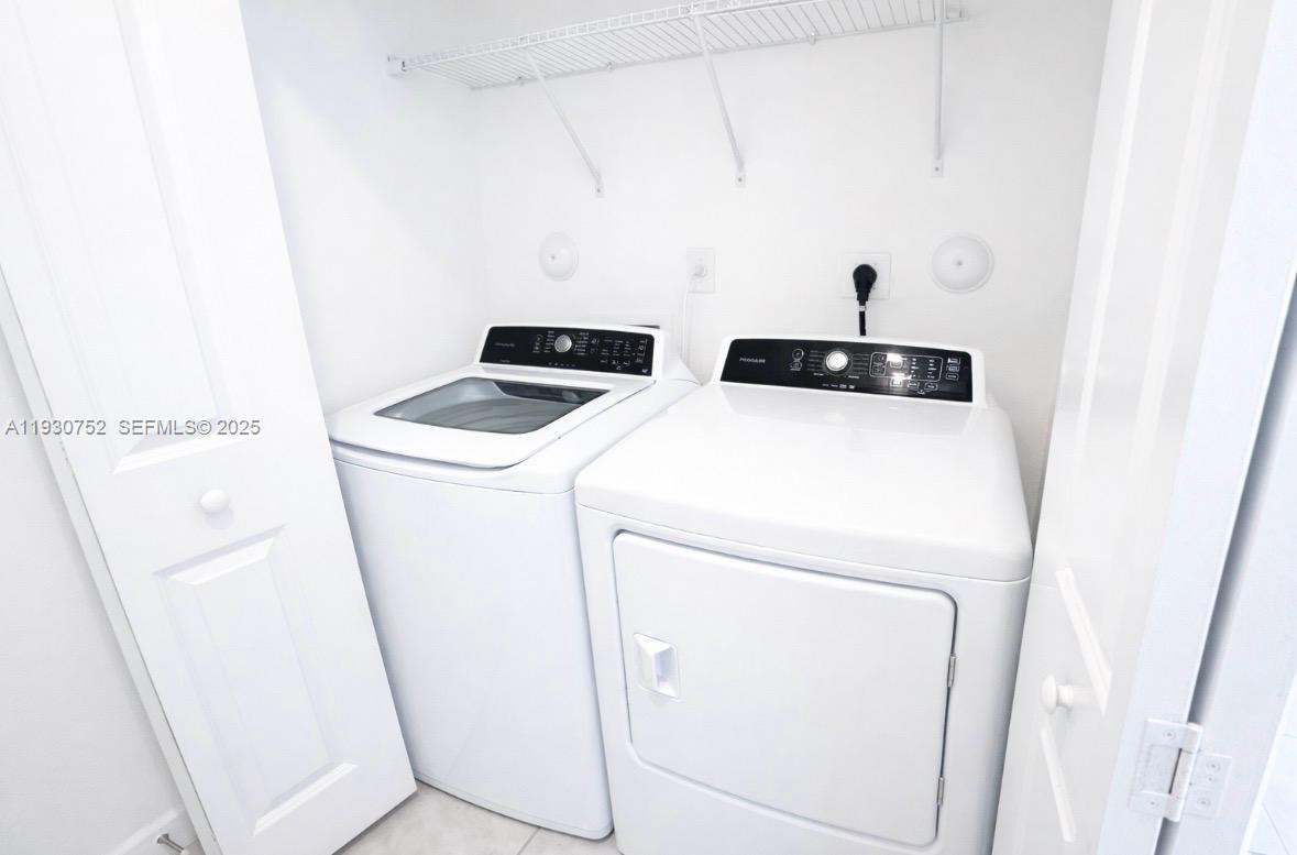 11956 Southwest 244th Lane, Unit 11956 Homestead, FL 33032 - Photo 6 of 7 a utility room with dryer and washer
