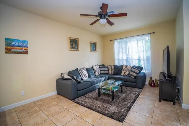 a living room with furniture rug and a window