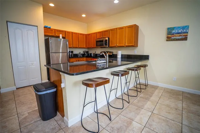 a kitchen with stainless steel appliances a refrigerator and a stove top oven
