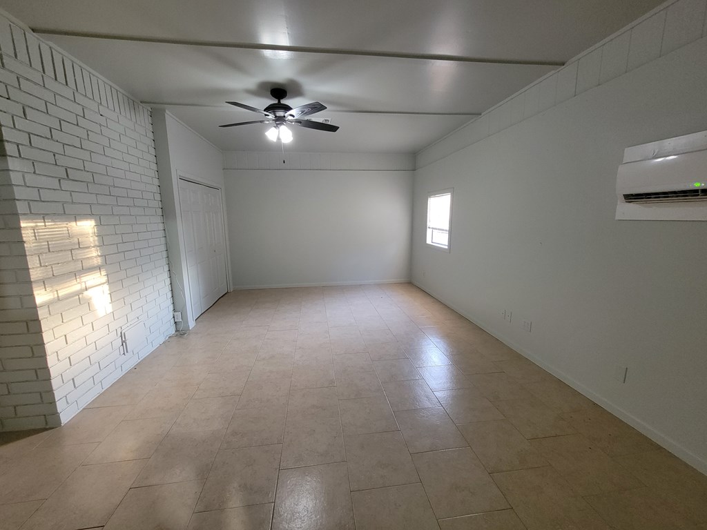 109 7th Street Ingram, TX 78025 - Photo 11 of 15 an empty room with a empty space and windows
