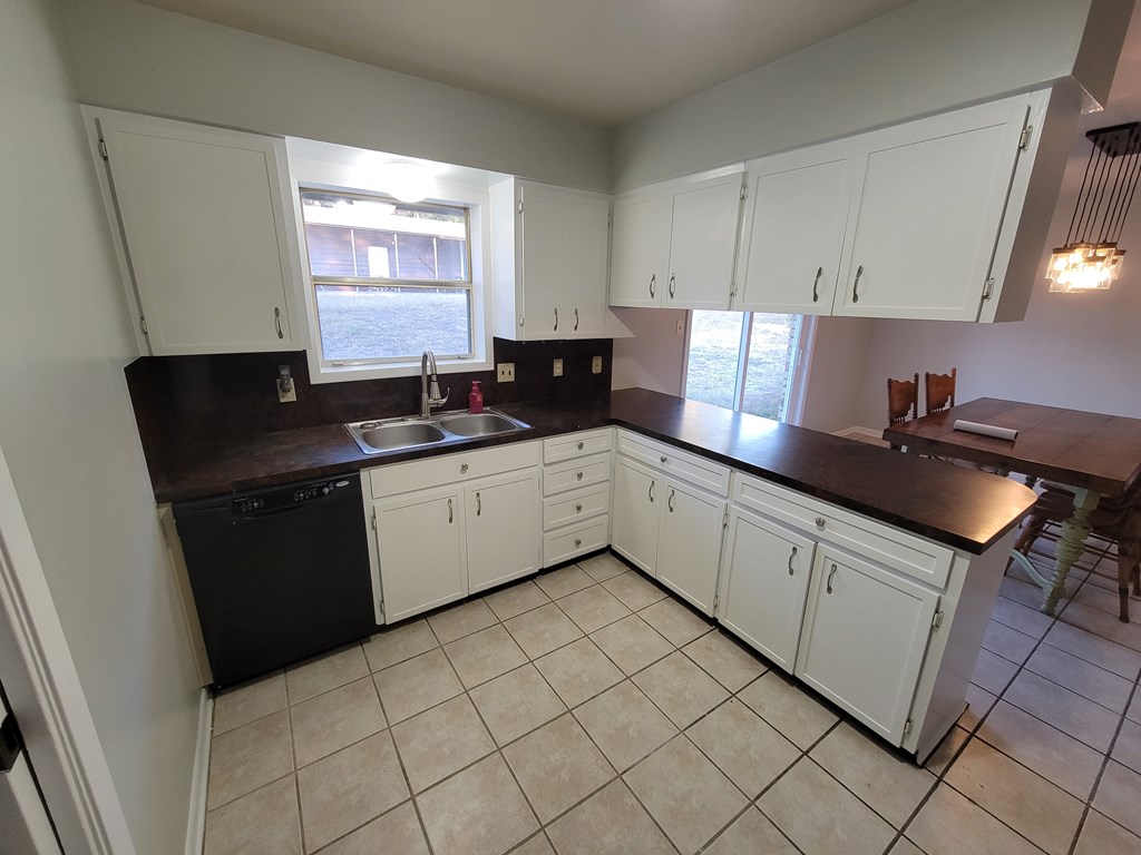 109 7th Street Ingram, TX 78025 - Photo 3 of 15 a kitchen with a sink cabinets and window