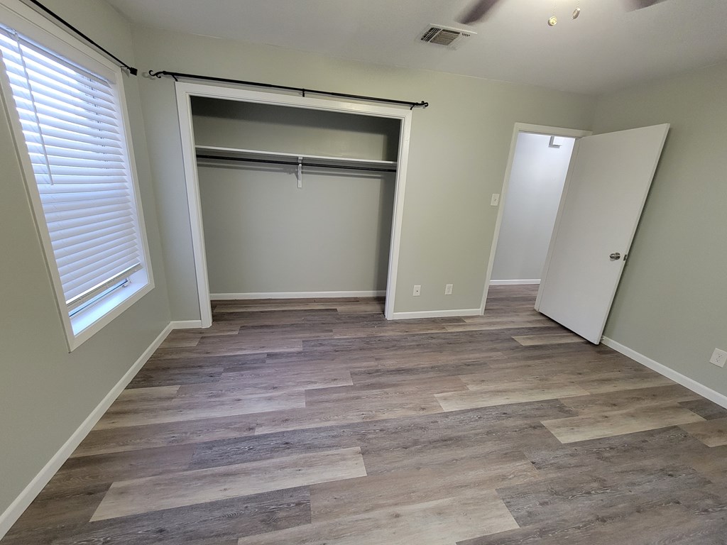 109 7th Street Ingram, TX 78025 - Photo 7 of 15 a view of an empty room with wooden floor and a window