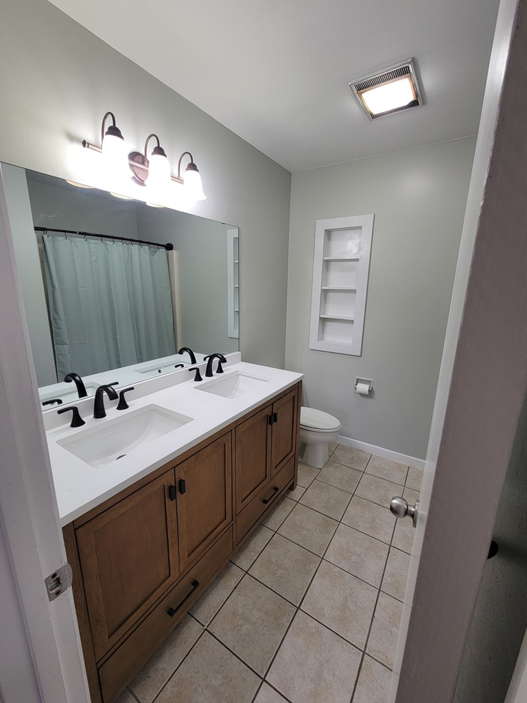109 7th Street Ingram, TX 78025 - Photo 10 of 15 a spacious bathroom with a double vanity sink a mirror and a vanity