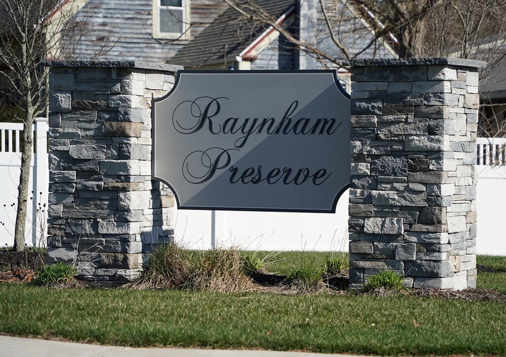79 Sparrow Way, Unit 1 Raynham, MA 02767 - Photo 2 of 3 a sign on the side of a building