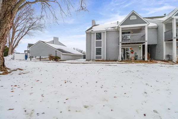 a view of garage with snow on the road