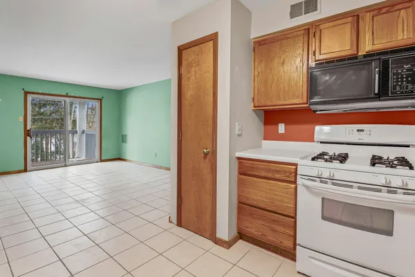 a kitchen with granite countertop cabinets stainless steel appliances and a window