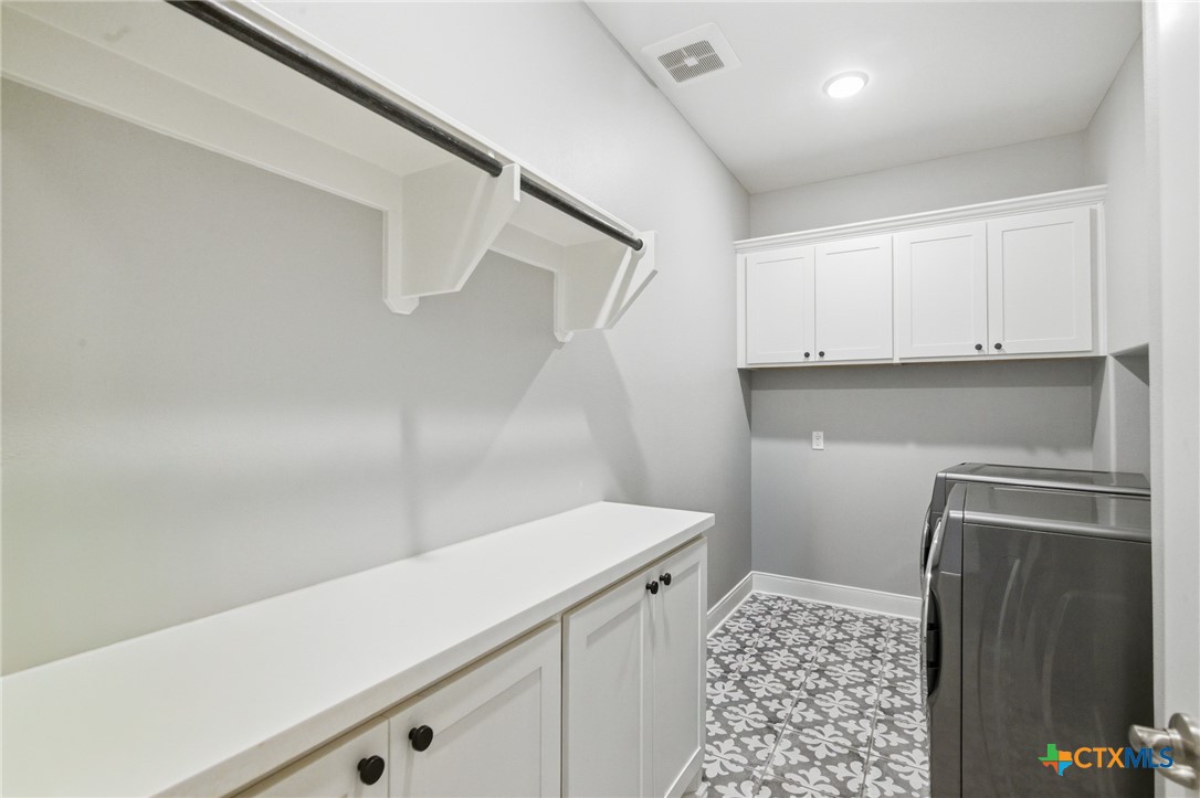 113 Terra Vista Ranch Road Victoria, TX 77904 - Photo 39 of 47 a utility room with cabinets washer and dryer