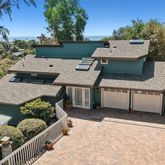 an aerial view of a house with balcony and garden space