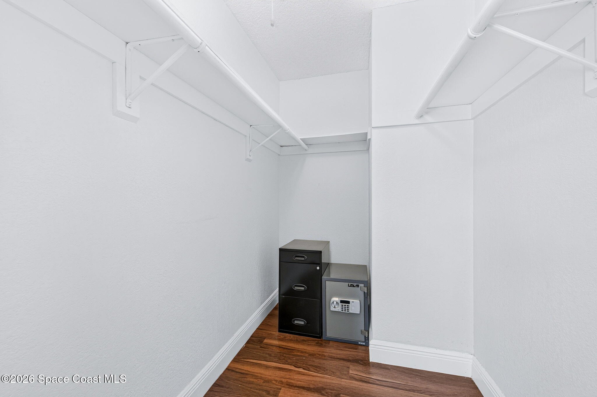 996 Botany Lane Rockledge, FL 32955 - Photo 24 of 35 a view of a hallway with wooden floor and a ceiling fan