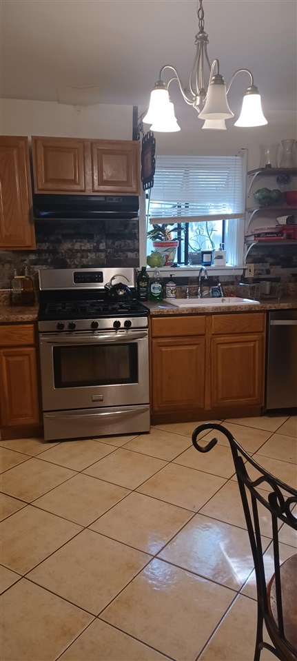 2920 Invergarry Road Memphis, TN 38128 - Photo 17 of 18 a kitchen with stainless steel appliances granite countertop a stove and a microwave