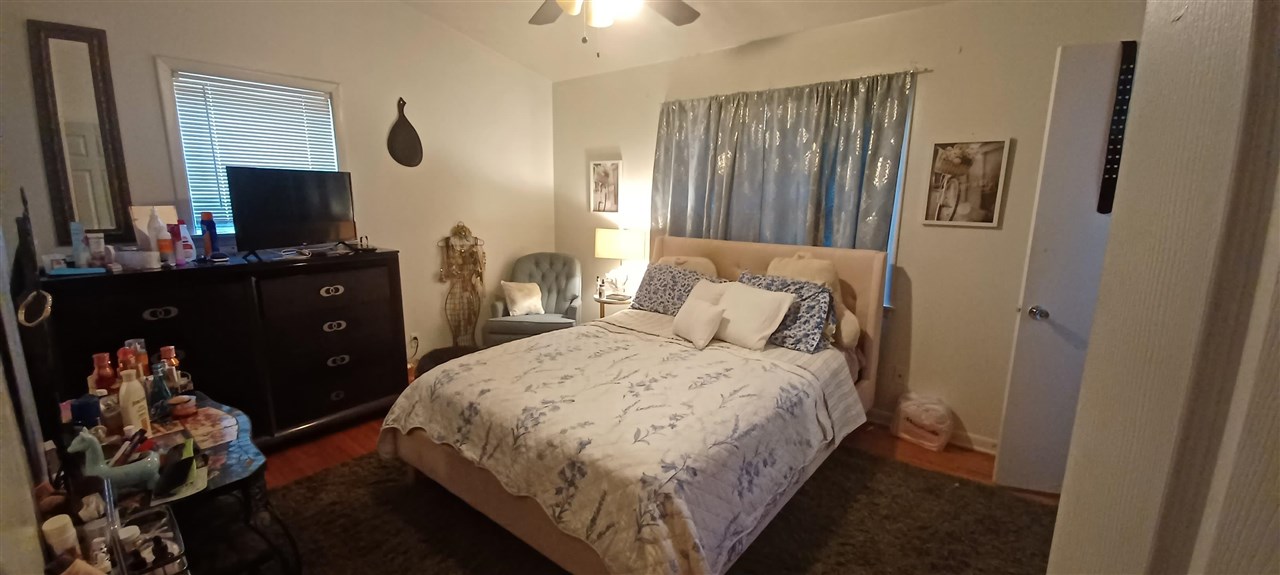 2920 Invergarry Road Memphis, TN 38128 - Photo 8 of 18 a bedroom with a bed and a flat tv screen on dresser