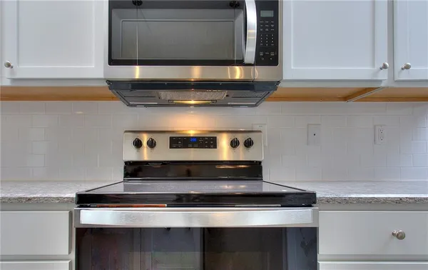 a stove top oven sitting inside of a kitchen