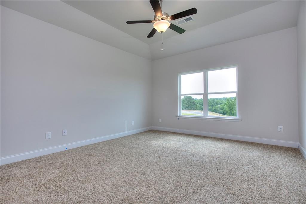 139 Swallowtail Lane Homer, GA 30547 - Photo 18 of 33 an empty room with a window and a ceiling fan