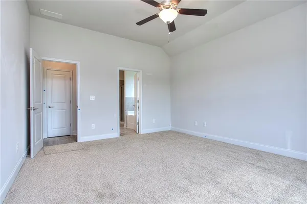 a spacious bathroom with a bathtub sink and mirror