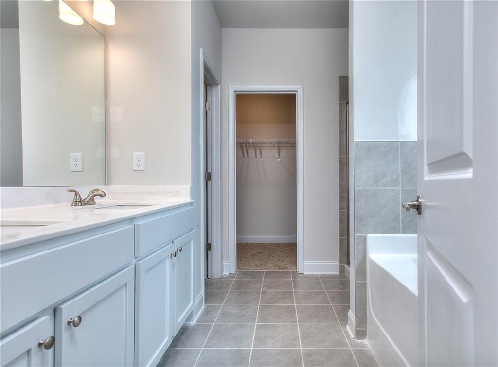 139 Swallowtail Lane Homer, GA 30547 - Photo 20 of 33 a spacious bathroom with a bathtub sink and mirror