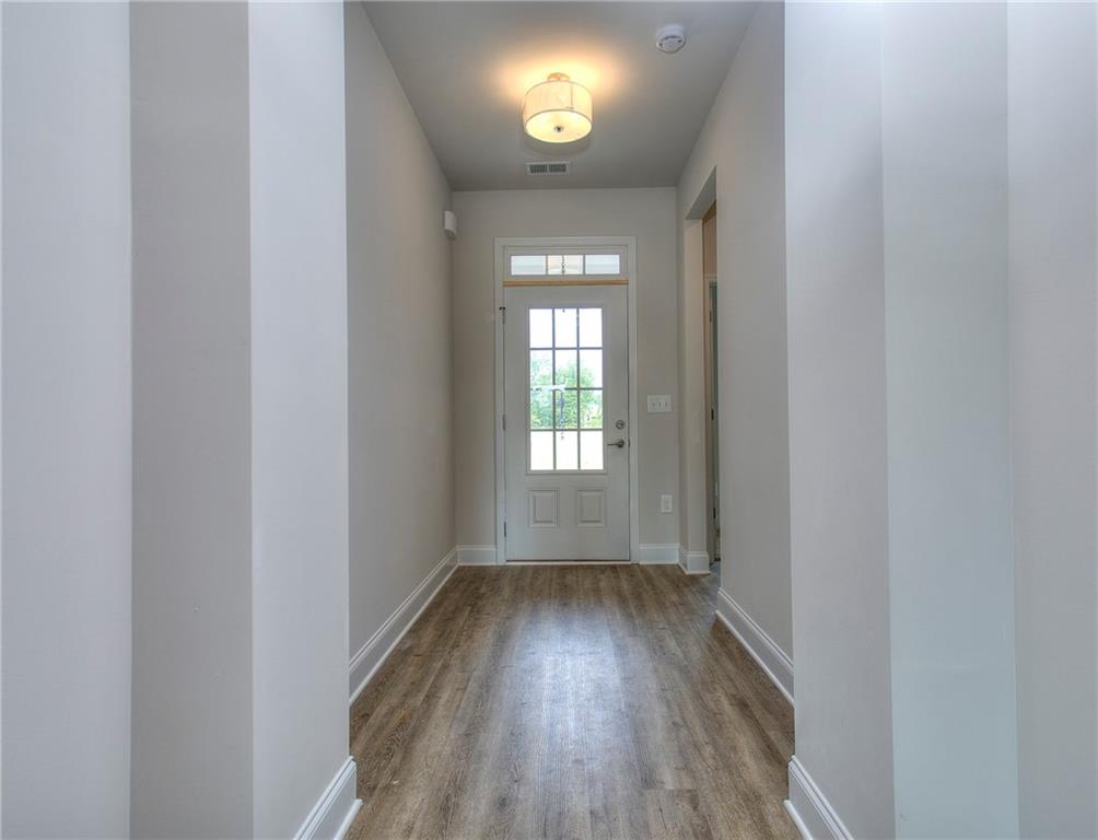 139 Swallowtail Lane Homer, GA 30547 - Photo 2 of 33 a view of an empty room with wooden floor and a window