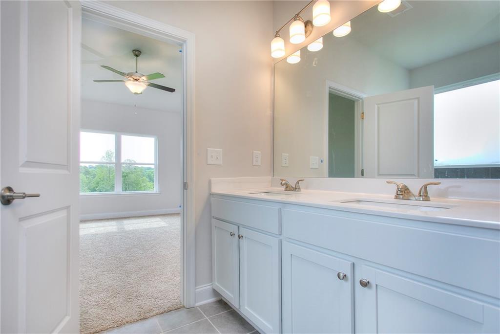 139 Swallowtail Lane Homer, GA 30547 - Photo 21 of 33 a bathroom with a double vanity sink and a mirror