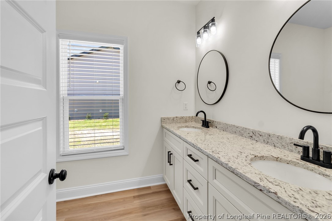 131 Merle Road Pinebluff, NC 28373 - Photo 20 of 33 a bathroom with a granite countertop sink and a mirror