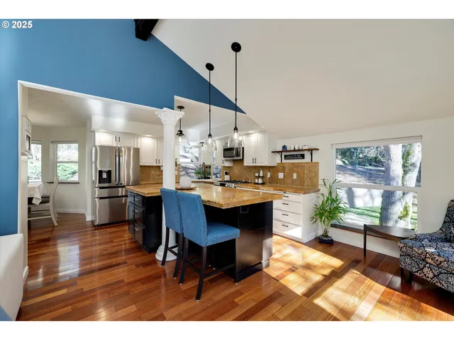a living room with furniture dining table a window and appliances
