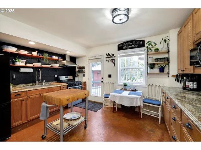 a kitchen with a appliances cabinets and a window