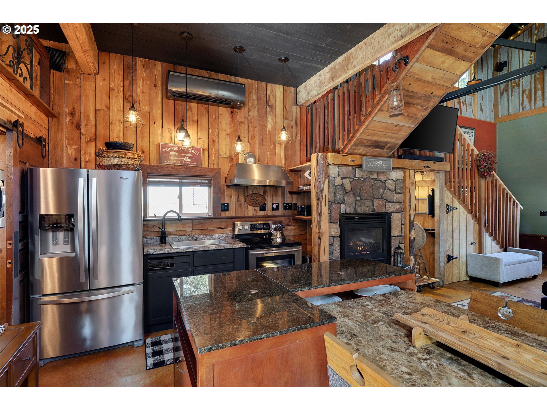 15451 Southeast Woodland Heights Road Amity, OR 97101 - Photo 36 of 48 a kitchen with stainless steel appliances granite countertop a refrigerator a fireplace a sink and a stove