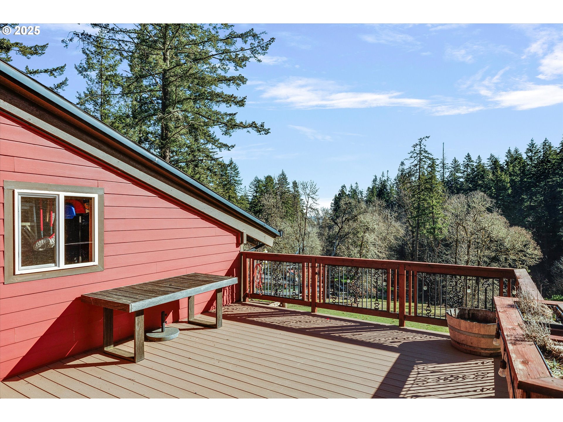 15451 Southeast Woodland Heights Road Amity, OR 97101 - Photo 40 of 48 a view of a balcony with wooden floor and iron fence