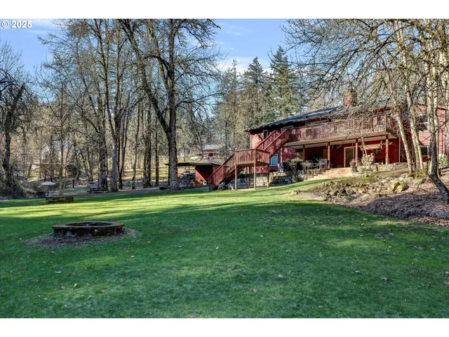 a view of a house with a big yard and sitting area