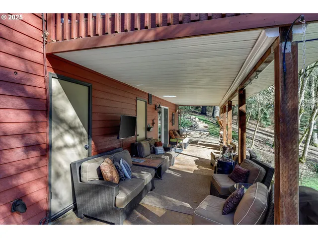 a living room with furniture a floor to ceiling window and floor to ceiling window