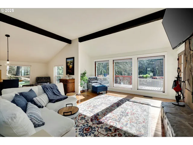 a bedroom with furniture and a large window