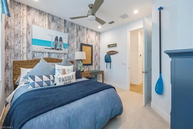 a bedroom with a bed mirror and window