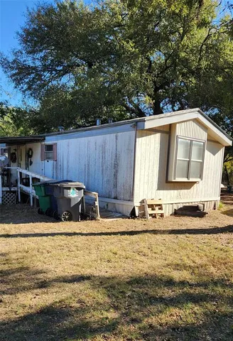 a view of a house with pool and sitting area