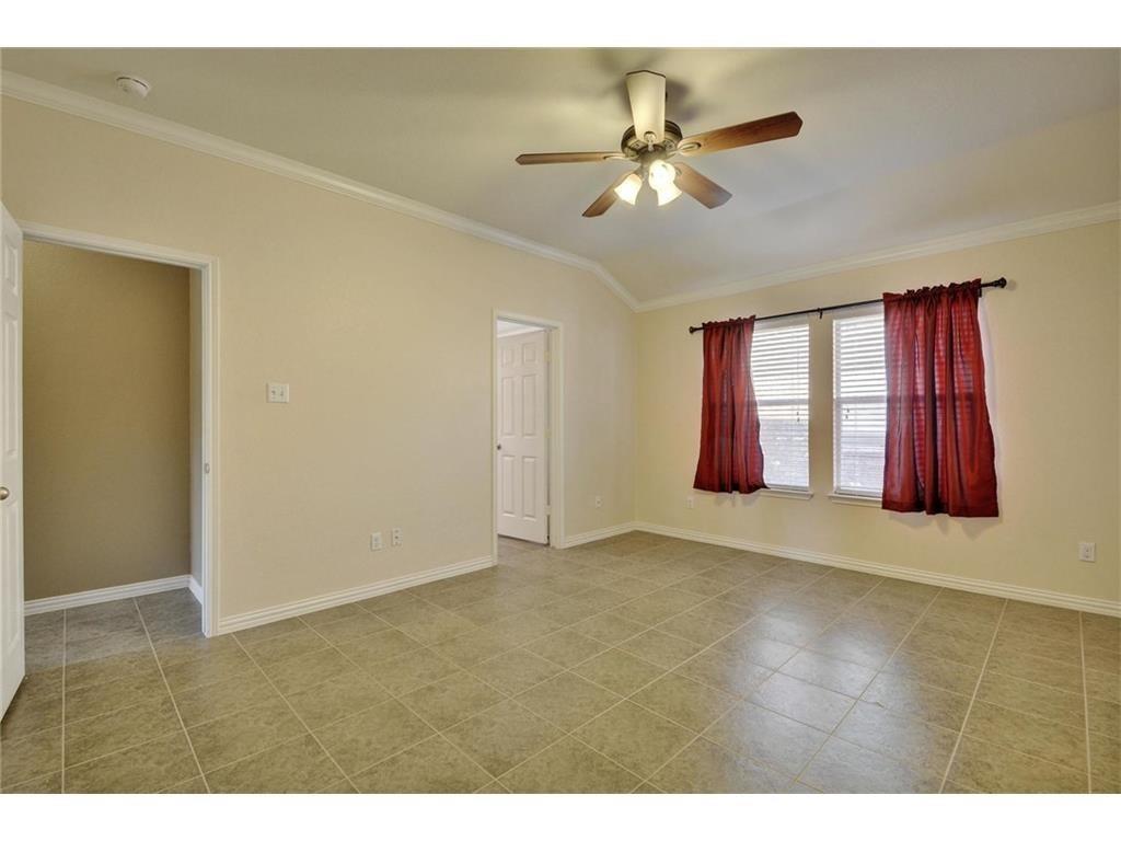 2109 Granite Springs Road Leander, TX 78641 - Photo 11 of 30 A well-lit room featuring a sloped ceiling and tiled flooring.
