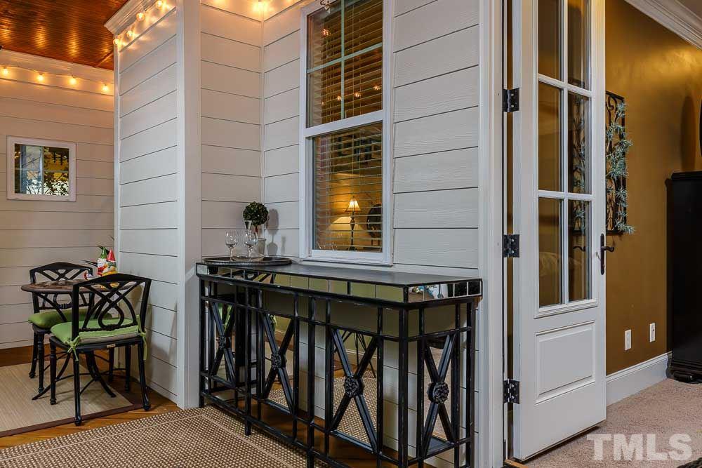 8103 Dreamy Way Raleigh, NC 27613 - Photo 13 of 25 Have lunch with a friend out on the porch. Feel free to pull down these bamboo privacy shades if the sun glistens through the trees.